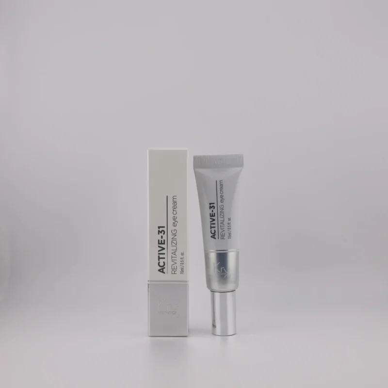 ACTIVE-31 Revitalizing Eye Cream in Tube mit silbernem Applikator neben passender Produktverpackung.